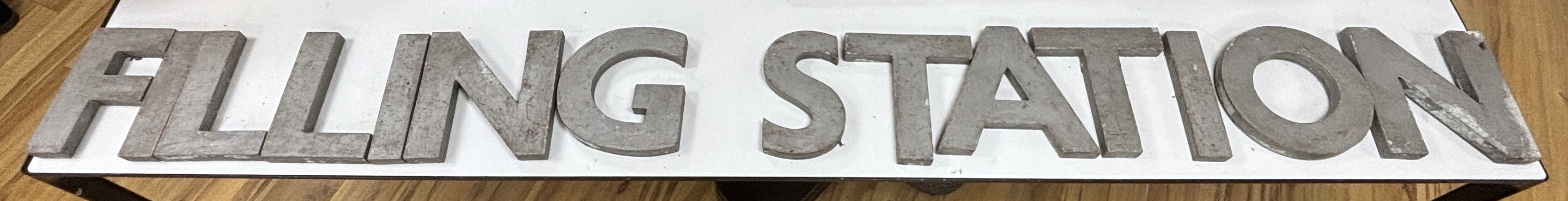 A collection of large metal letters spelling ' Filling Station' letters 23cm high (14)